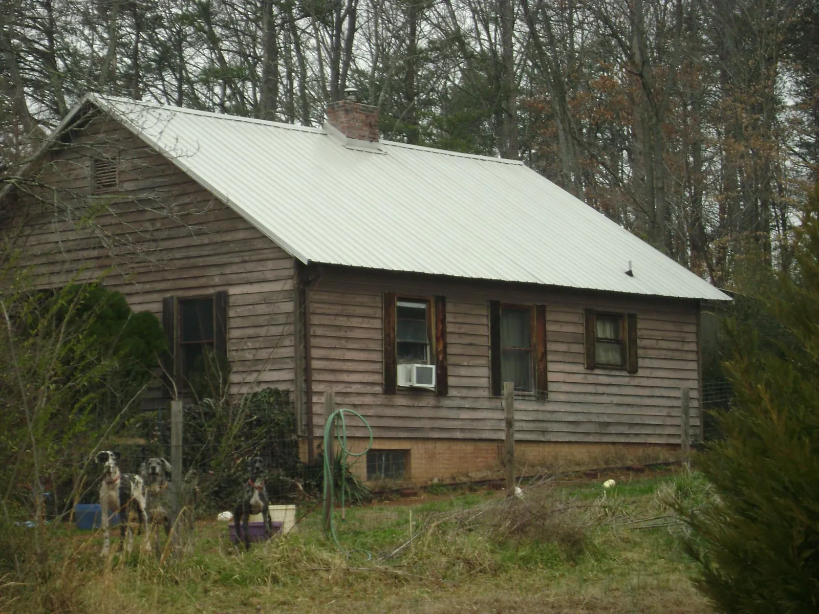 White metal roof on an old wood sided farmhouse, from a Metal Roof Installation job in Center Point